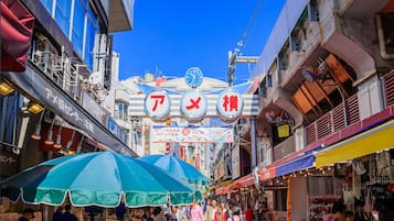 A bustling street market with vendors and shoppers.