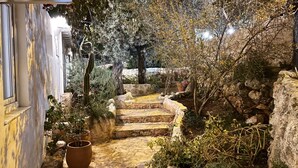 A stone staircase leading to a garden area with potted plants and a cactus. - Kaktus Beach Apart (Kas)