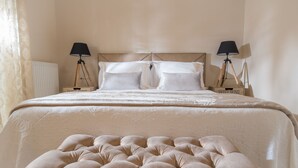 A neatly made bed with a tufted headboard, two bedside lamps, and a sign that reads "Sweet Home" on the nightstand. - Villa Artemis, Wine Dark Sea Villas (Malevizi)