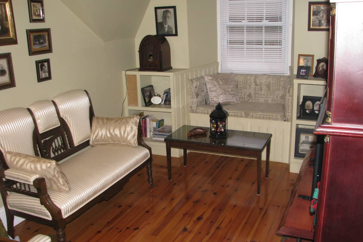 A living room with a sofa, a coffee table, and a bookshelf.