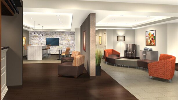 A modern living room with a fireplace, comfortable seating, a dining area, and a kitchen. - Extended Stay America Suites Rock Hill (Rock Hill)