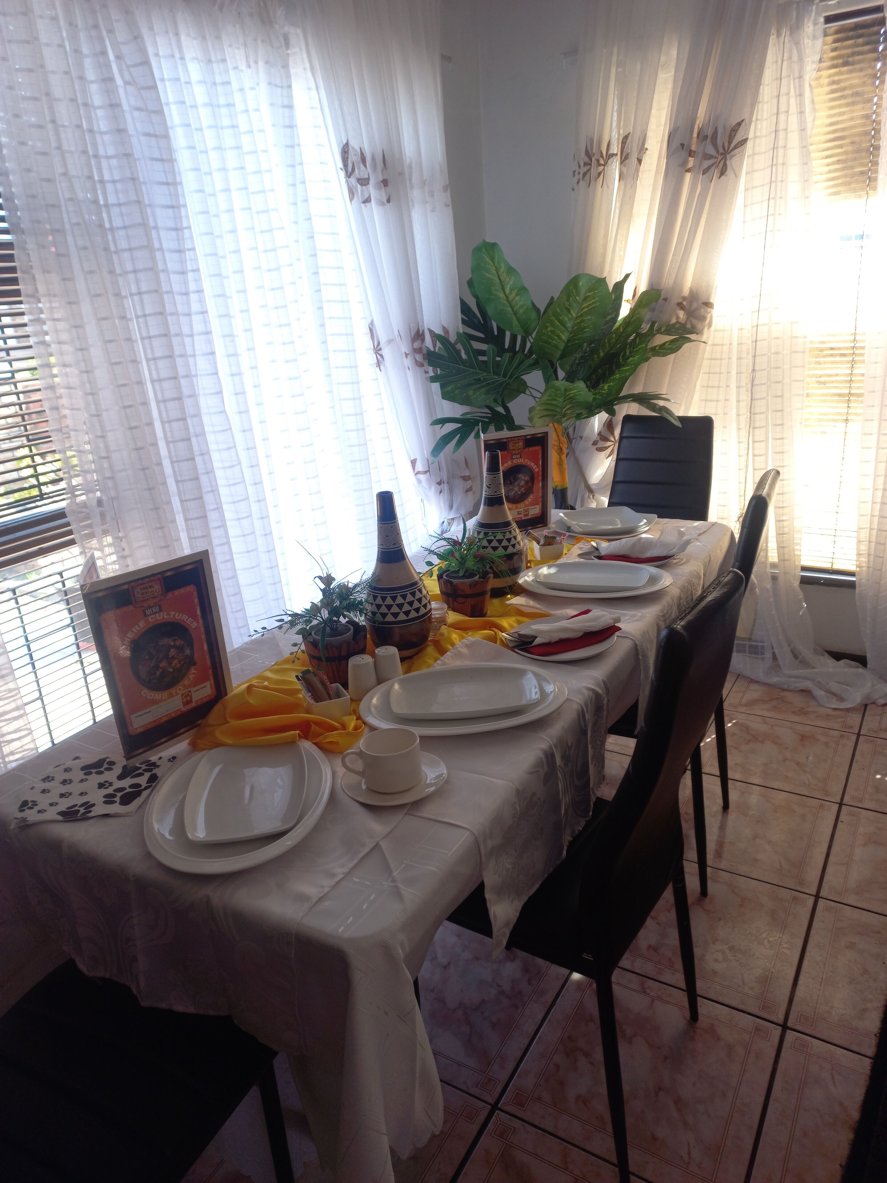 A dining table set with plates, a cup, and decorative items.