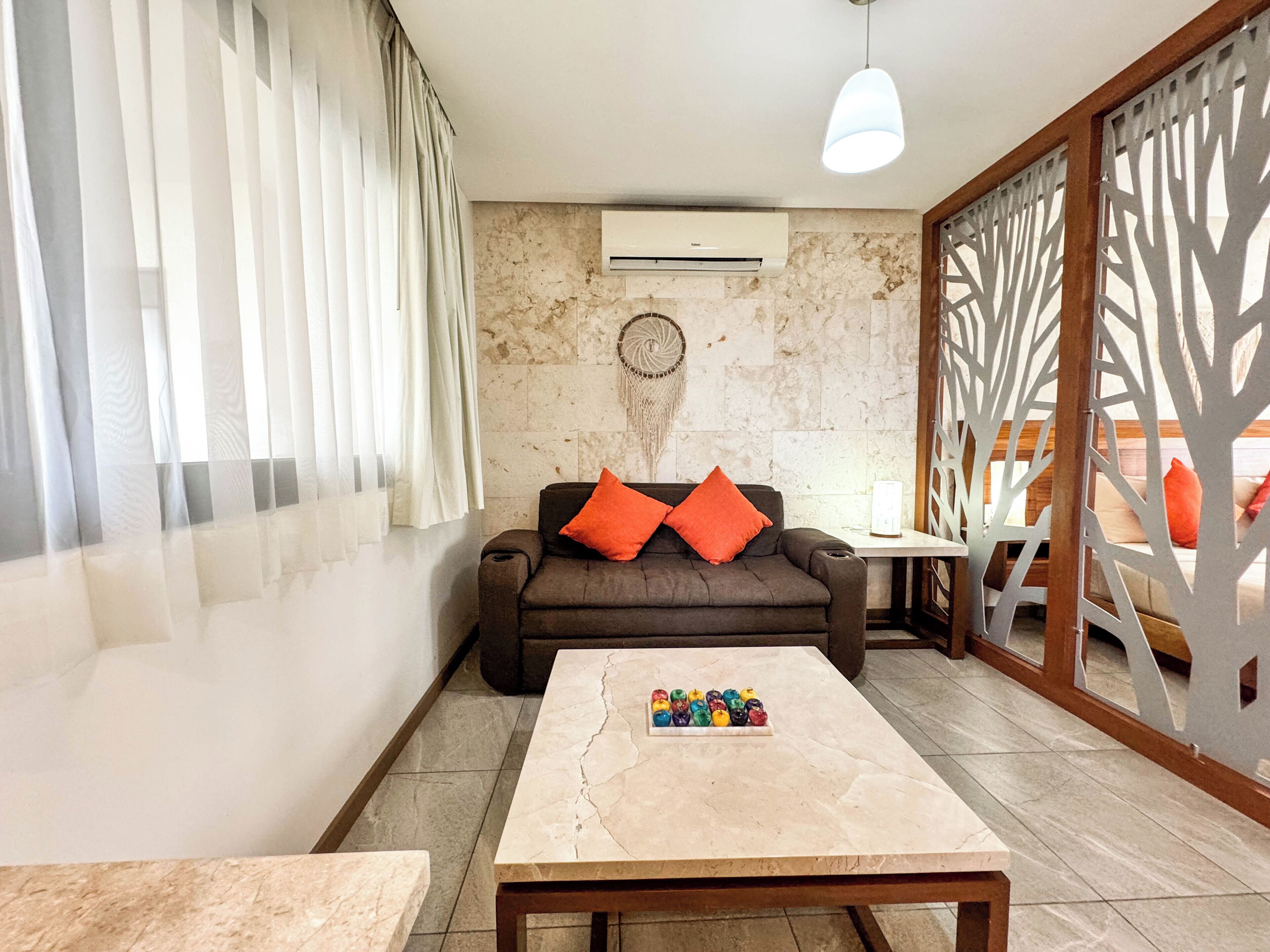 A modern living room with a sofa, a coffee table, and a decorative wall piece.