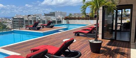 Piscine extérieure, parasols de plage, chaises longues