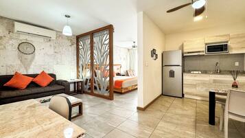 A modern apartment with a living room, kitchen, and bedroom.