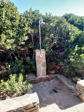 A stone structure with a water feature, surrounded by dense foliage. - Wonderful view of the sea. Romantic and relaxing place suitable for a couple. (Sassari)