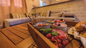 A wooden table with a fruit and dessert tray, a bowl of berries, and a croissant. - Villa Noja***** HEATED POOL, beaches, volcano, hiking, Trail... (Saint Louis)