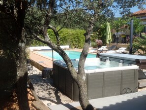 A swimming pool area with a hot tub, lounge chairs, and a pergola. - Villa with trees, pool and spa (Sainte-Anastasie-Sur-Issole)