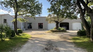 A two-story building with a gravel driveway leading to a garage. There are trees and shrubs around the property. - Drôme provençale, nature, outdoor swimming pool and spas  (La Baume-De-Transit)