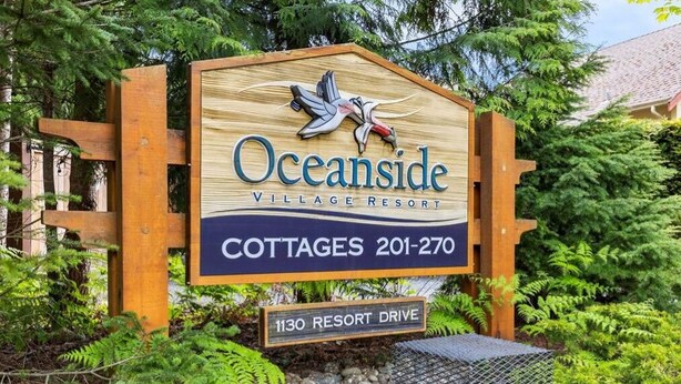 A sign for Oceanside Village Resort, indicating cottages available at 201-270 and located at 1130 Resort Drive. - 3 bed 2 bath, Wifi, Cable, Pool/Hot Tub, BBQ, Mini Golf, Beach, license#00005785 (Parksville)