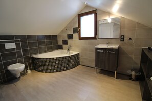 Bathtub, hair dryer, soap, toilet paper