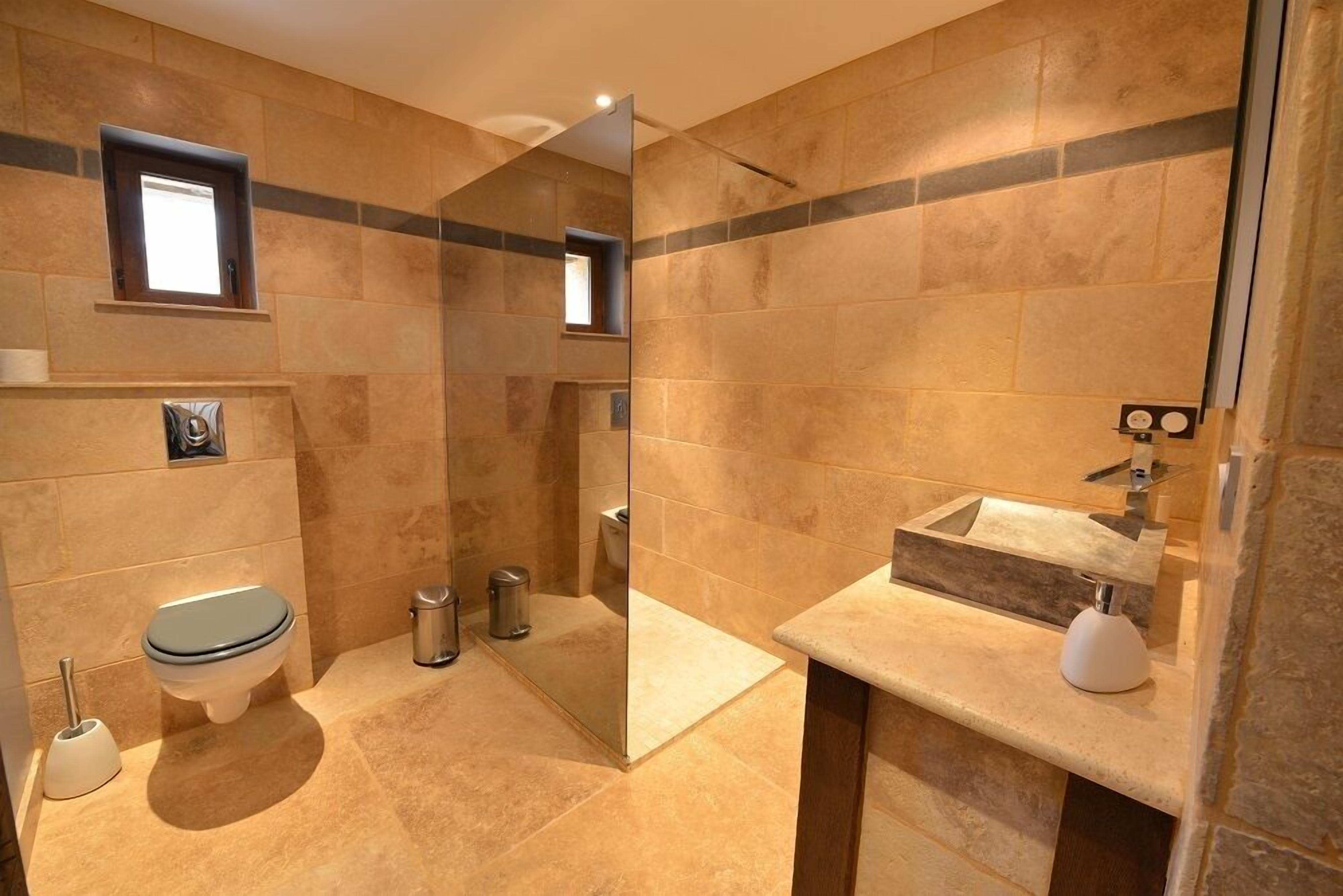 Une salle de bain moderne équipée de toilettes, d’un bidet et d’un lavabo.