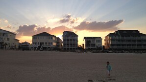 A beach with houses in the background.