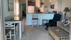 A compact living space with a kitchen, dining area, and seating area.