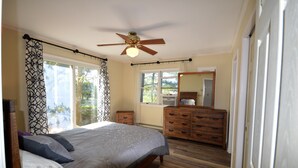 A bedroom with a bed, a ceiling fan, a dresser, and a large window. - Waterfront Tranquil Escape-Single Family/Gated Community/Pool/Tennis Courts  (Lewes)