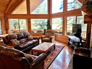 Main floor living area with reclining sofas and new la-z-boy recliner.