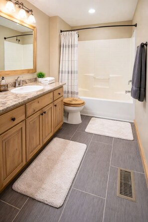A bathroom with a wooden vanity, a sink, a toilet, a shower, and a bathtub. - Luxury Duck Creek Log Cabin, ATV Trails Access, Near Zion, Bryce, & Brian Head (Duck Creek Village)