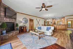 Cozy living area with a fireplace, sofa, and coffee table.