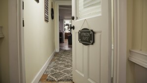 A hallway with a rug leading to a door labeled "STINSON SUITE."