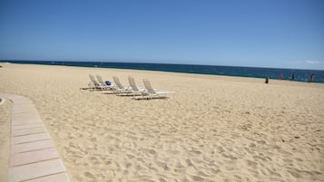 On the beach, sun loungers, beach towels