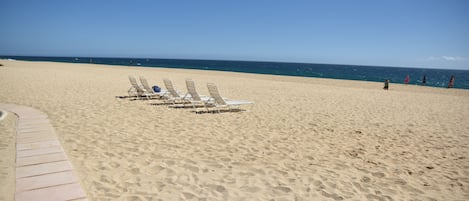 On the beach, sun-loungers, beach towels