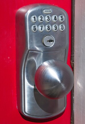 A metallic door lock with a numeric keypad and a round handle. - The Cary Cottage 1 BR 1 BA Private Sleeps 4 - Downtown Cary, Eat Drink Play Shop (Cary)