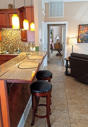 Enjoy cooking in this well-equipped kitchen with a central island, wooden cabinets, and a stainless steel sink.