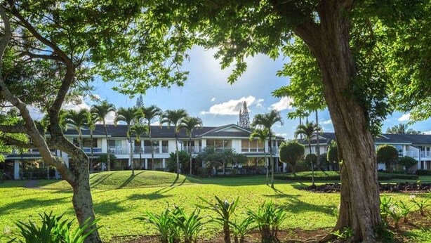 A hotel with a large lawn, multiple buildings, and trees. -  A/C, Deluxe, Top Floor, Quiet Development, heated pool, convenient location (Princeville)