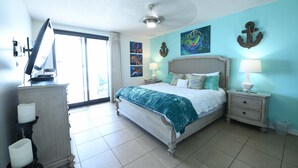 A bedroom with a bed, nightstands, a dresser, and artwork on the walls. - Phoenix10 Beach front condo fully upgraded with brand new custom bathrooms. (Orange Beach)