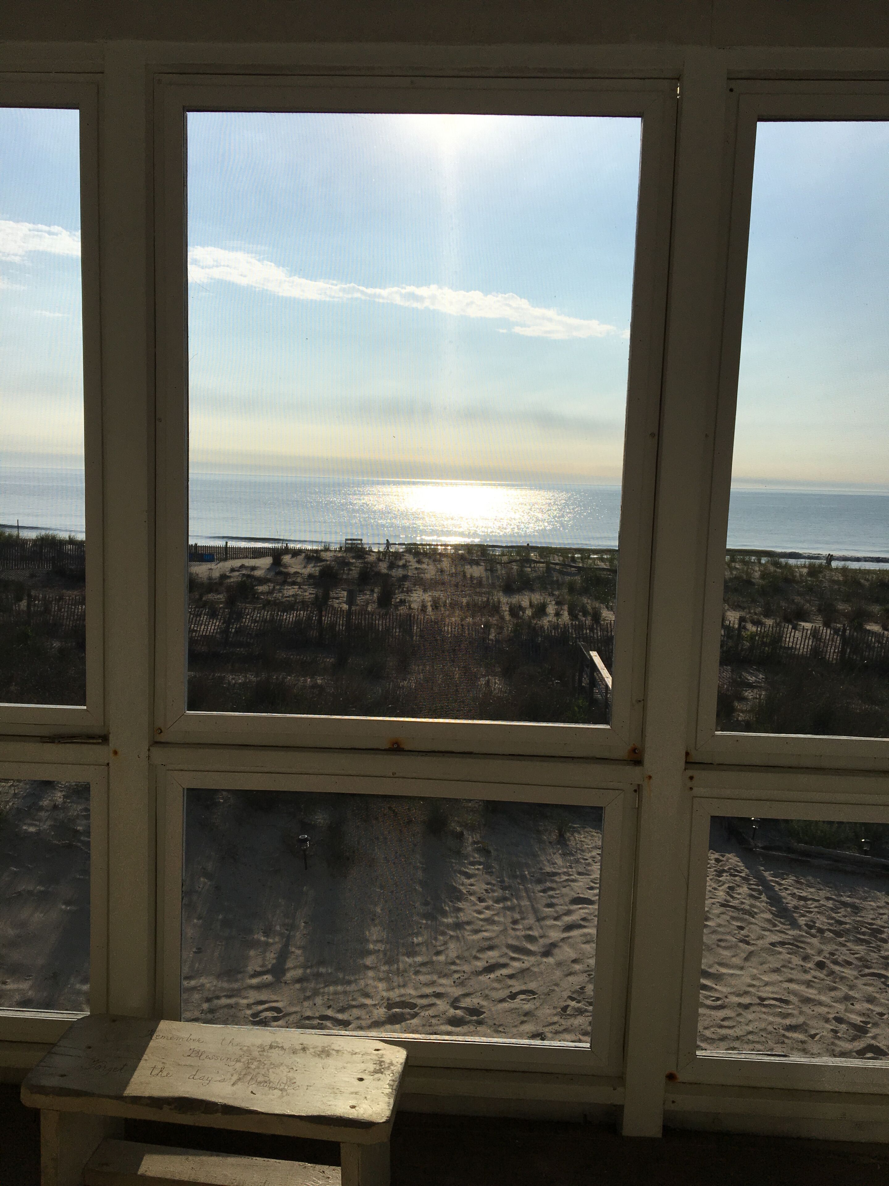 A view through a window with a bench in front.