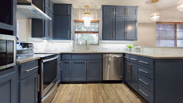 A modern kitchen with dark cabinets, stainless steel appliances, and a wooden floor. - 3/2
1 Mile to Main St! (Fredericksburg)