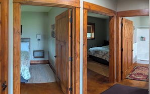 A hallway with wooden doors leading to a bedroom and a bathroom. - Ahhh, Montana! Peace & Quiet With Spectacular Views! (Stevensville)