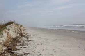 Enjoy a serene beach experience with a gentle slope leading down to the calm ocean.