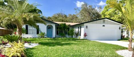 A single-story house with a white exterior, a front porch, and a garage.