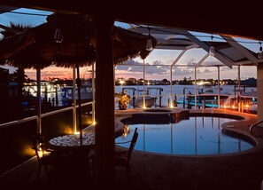 An outdoor pool area with a view of the marina and sunset. - Waterfront Pool Home with Dock directly On Bal Harbor (Apollo Beach)