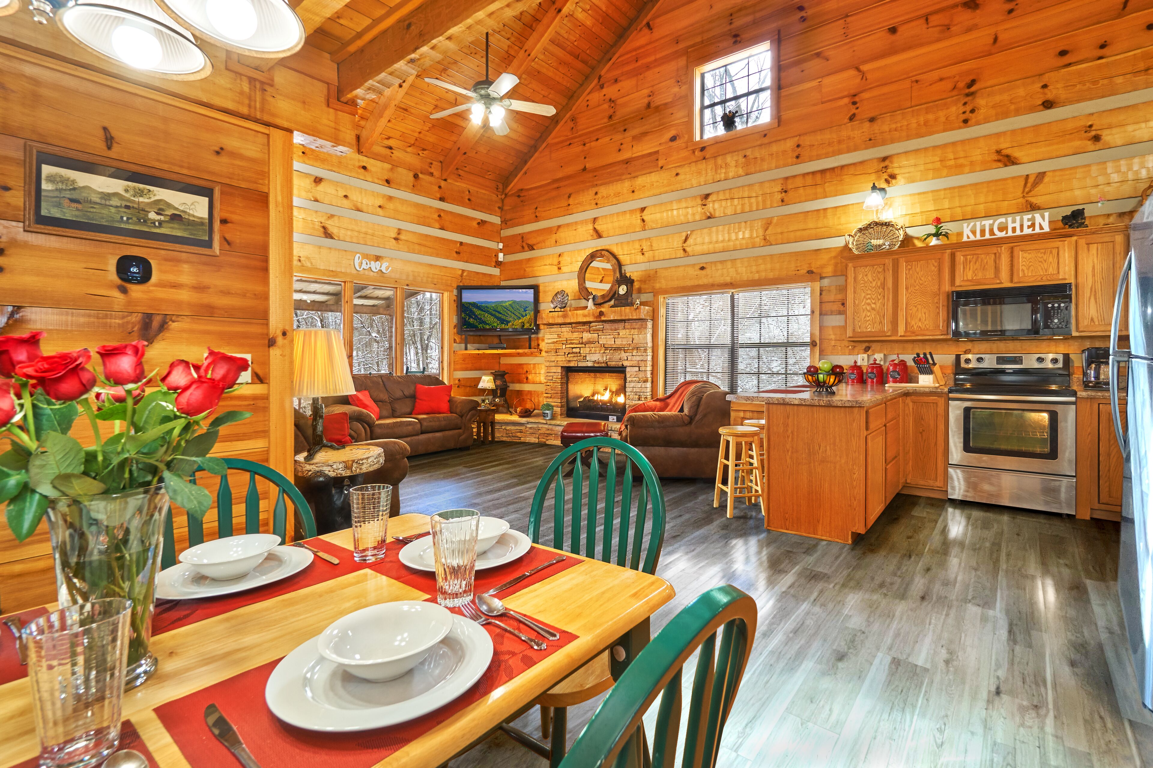 A cozy log cabin interior with a dining area, kitchen, and living room.