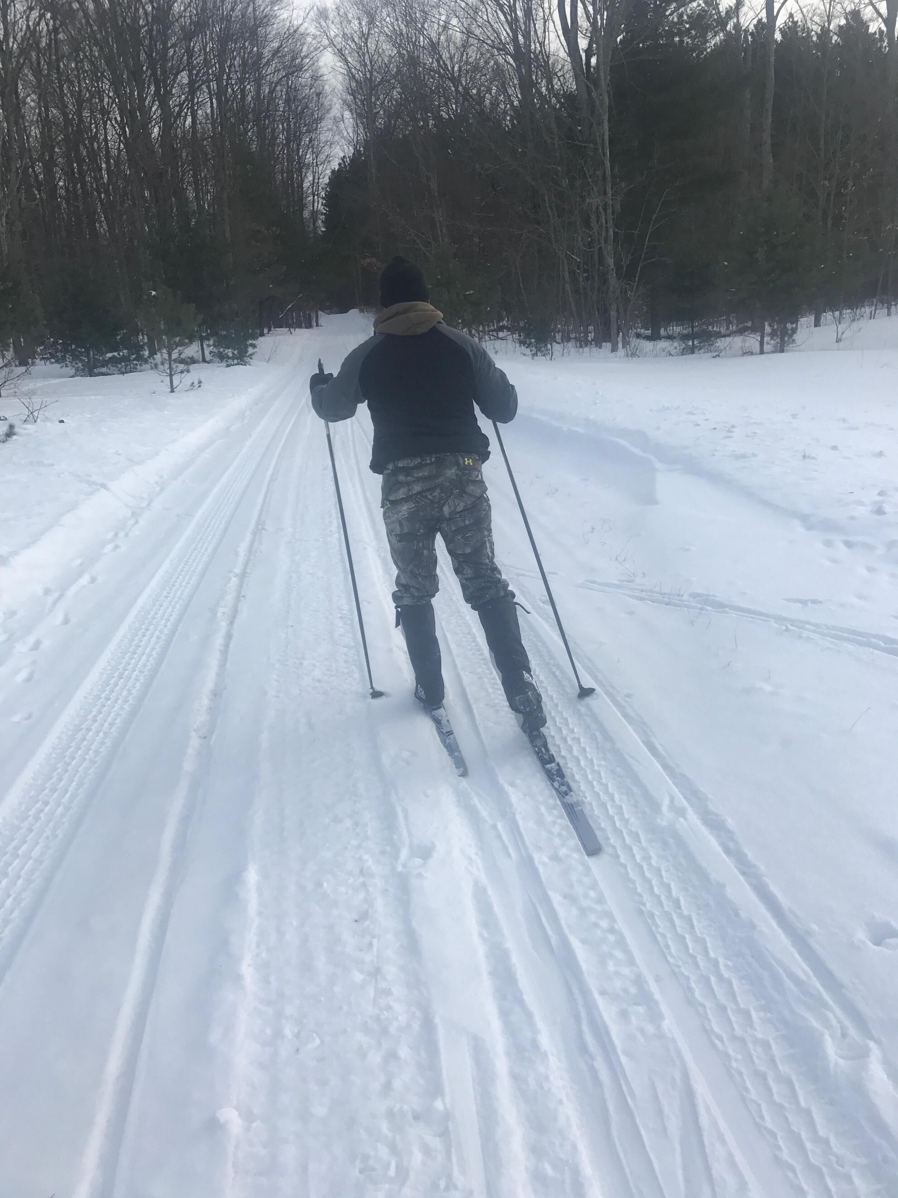 A person skiing on a snow-covered path.