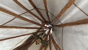 Eine Decke mit Holzbalken, die von einem Mittelpunkt ausgehen.