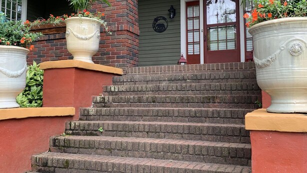 A set of stone steps leading to a house entrance with a brick column and a door with a window. - Bear House 1890, Johnson Retreat, Mins from Downtown, Perfect Luxurious Getaway! (Chattanooga)