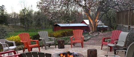 A patio area with outdoor seating and a fire pit.