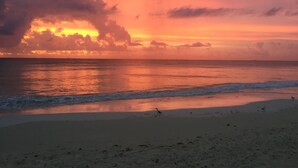 A beach with waves and a sunset. - Spacious, quiet and safe condo one block from the beach in Playacar (Playa del Carmen)