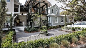 A two-story house with a prominent attic and a covered front porch. - Walk to the Beach and Downtown Restaurants, Bars, and Shops! (Ocean Springs)