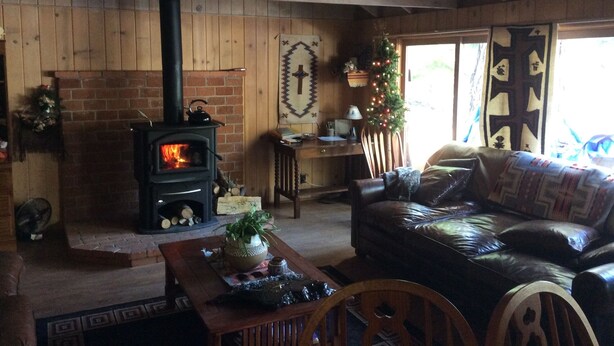 A cozy living room with a brick fireplace, a leather sofa, and a wooden ceiling. - Fallen Leaf Lake is Widely Considered the Most Scenic Place around Lake Tahoe (South Lake Tahoe)
