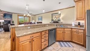 A spacious kitchen with granite countertops, wooden cabinets, and stainless steel appliances. - Panoramic Luxury Retreat with Mountain View’s (Banner Elk)