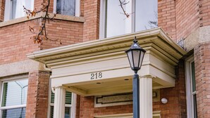 A brick building with a white entrance and the number 218. - Quaint Downtown Condo (Salt Lake City)