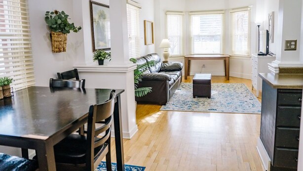 A modern living room with a dining table, sofa, and a small coffee table. - Quaint Downtown Condo (Salt Lake City)