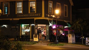 A two-story building with a sign reading "Water Prince Corner Shop."