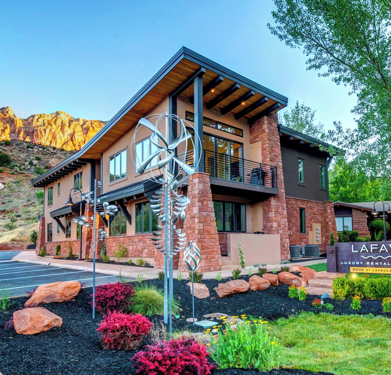 A modern two-story building with a prominent sign reading "Lafave Luxury Rentals at Zion".