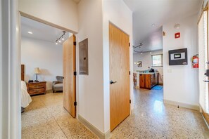Enter a spacious room with a comfortable bed, a kitchenette, and a TV.