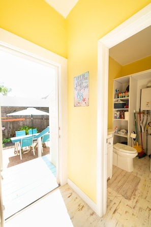Enjoy an outdoor space with a patio, table, and chairs, and a convenient door leading to the great outdoors.